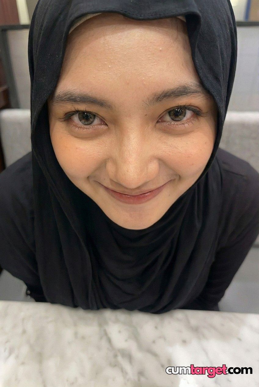 Target Smiling Woman in Black Hijab