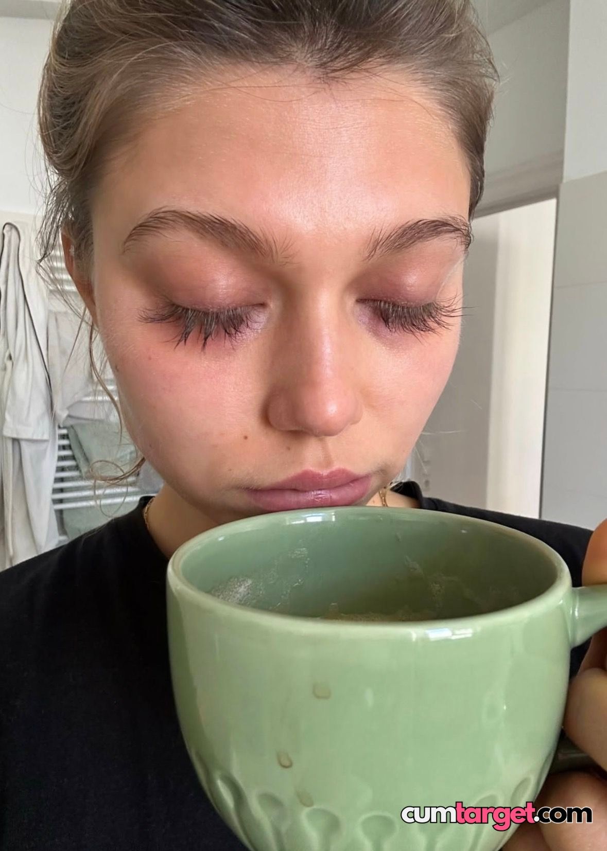 Spray on Woman Sipping from Green Mug