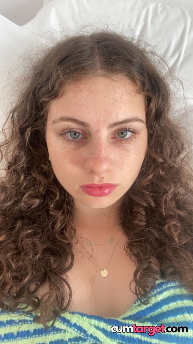 Spray on Curly-haired woman close-up