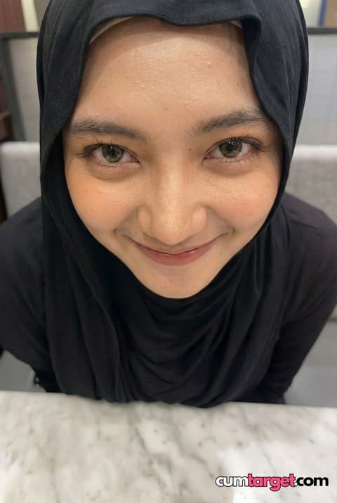 Target Smiling Woman in Black Hijab