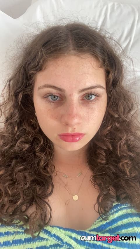 Spray on Curly-haired woman close-up