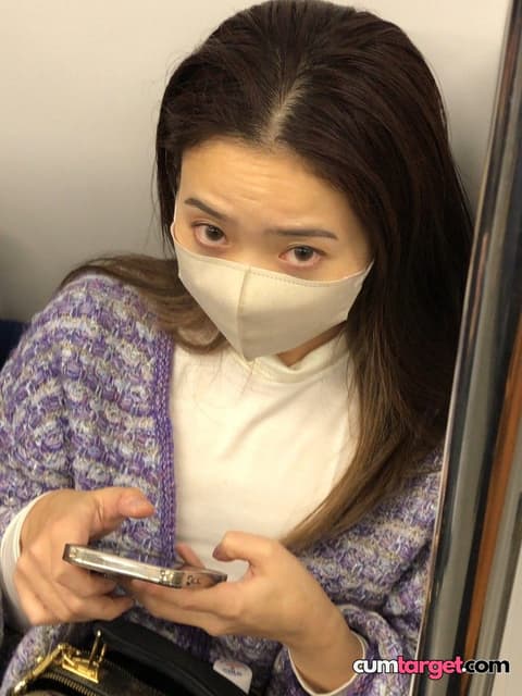 Target Woman Wearing Mask Using Phone