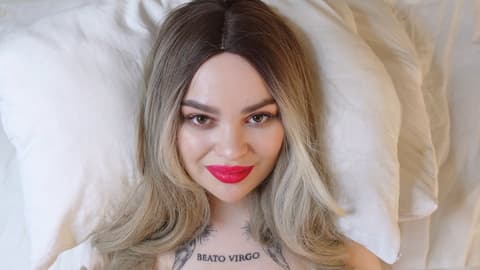 Smiling Woman Lying on Pillow