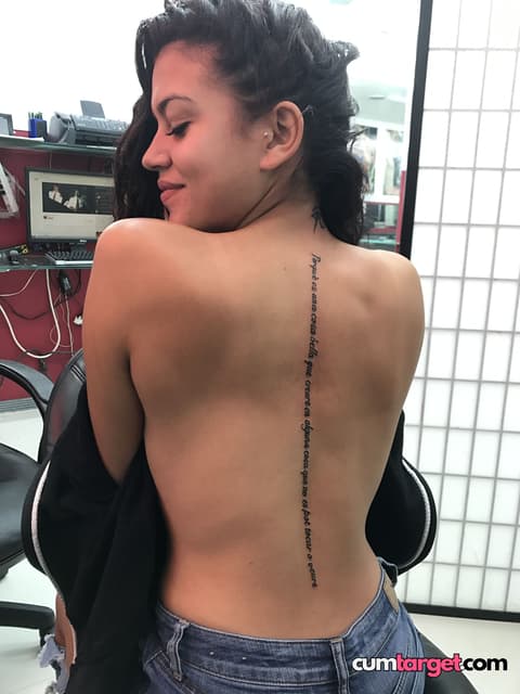 Spray on Smiling Woman Showing Back Tattoo